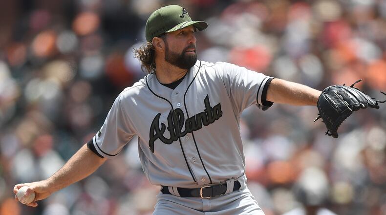 The Braves’ R.A. Dickey pitches against the San Francisco Giants at AT&T Park on Sunday. He allowed seven runs, six earned, in the first three innings. (Photo by Thearon W. Henderson/Getty Images)