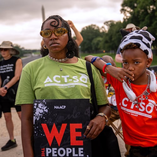 Demonstrators listen to speakers during the March on Washington, Friday, Aug. 28, 2026, near the Lincoln Memorial in Washington. (AP Photo/Julia Demaree Nikhinson)