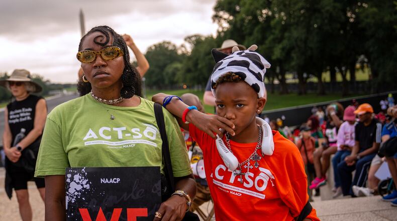 Demonstrators listen to speakers during the March on Washington, Friday, Aug. 28, 2026, near the Lincoln Memorial in Washington. (AP Photo/Julia Demaree Nikhinson)