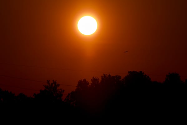 The sun rises at the overlook of the reservoir at Shirley Clarke Franklin Park, Tuesday, June 24, 2025, in Atlanta. The heat index, which measures how hot it feels by taking into account air temperature and humidity, was projected to reach up to 107 degrees. (Jason Getz/AJC)