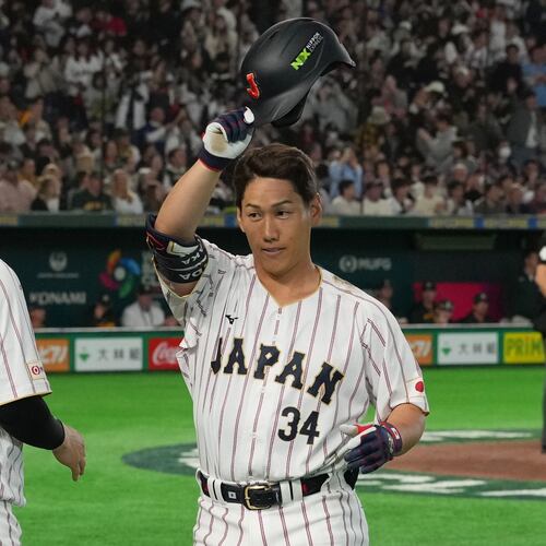 Japan's Masataka Yoshida, center, reacts after hitting two-run home run during the seventh inning of a World Baseball Classic game between Japan and Australia on Sunday, March 8, 2026 in Tokyo. (AP Photo/Hiro Komae)