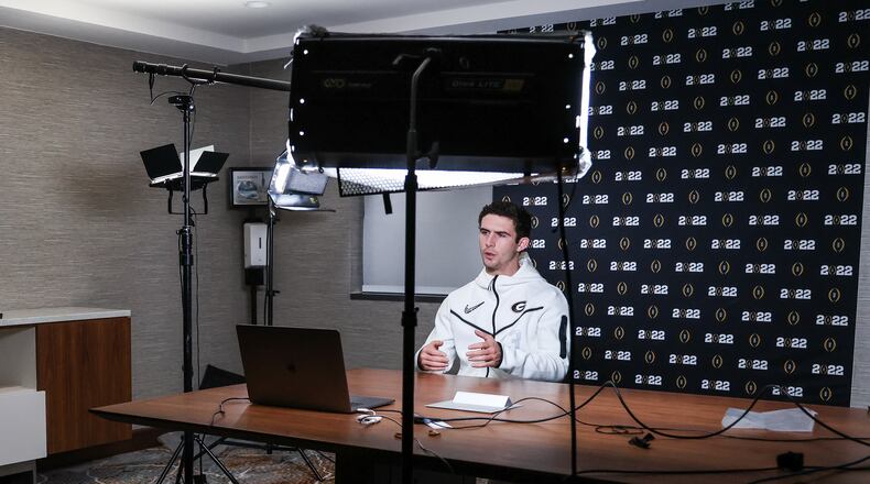 Georgia quarterback Stetson Bennett had more trouble with an earpiece that he had to wear during a 'virtual press conference' conducted in Indianapolis, Ind., on Saturday than he has with most opposing defenses he has faced this season. (Photo by Tony Walsh/UGA Athletics)