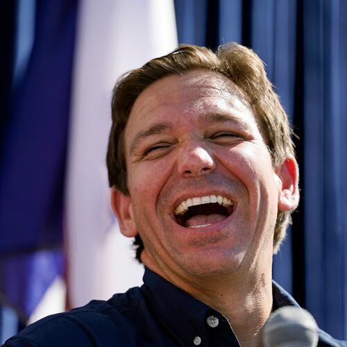 FILE - Republican presidential candidate Florida Gov. Ron DeSantis laughs at the Iowa State Fair, Aug. 12, 2023, in Des Moines, Iowa. (AP Photo/Jeff Roberson, File)