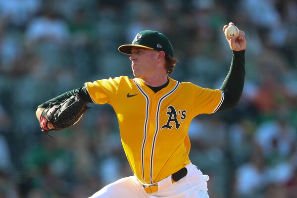 Athletics pitcher JP Sears throws to an Atlanta Braves batter during the first inning of a baseball game Thursday, July 10, 2025, in West Sacramento, Calif. (AP Photo/Scott Marshall)