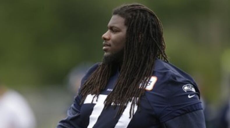 Seattle Seahawks guard James Carpenter stands on the sidelines during a practice drill, Tuesday, May 28, 2013, at an NFL football organized team activity in Renton, Wash. (AP Photo/Ted S. Warren)