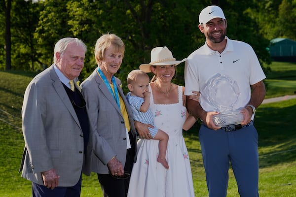 Scottie Scheffler, right, holds the trophy as he poses for a photo with his wife Meredith, second from right, and son Bennett, center, and Jack, left, and Barbara Nicklaus, second from left, after winning the Memorial golf tournament Sunday, June 1, 2025, in Dublin, Ohio. (AP Photo/Sue Ogrocki)