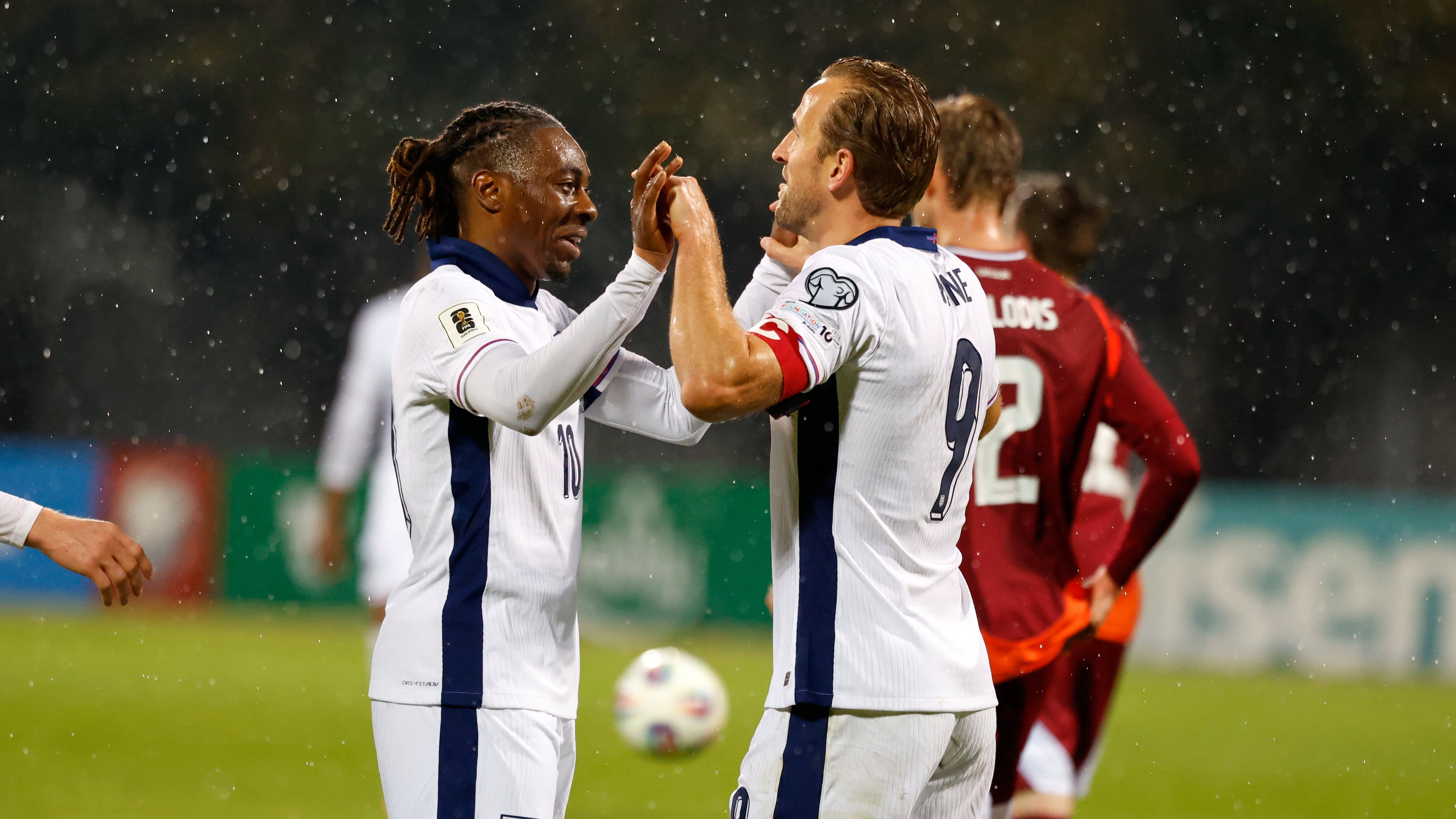 England's Eberechi Eze, left, celebrates with Harry Kane after scoring his side's fifth goal during the 2026 World Cup group K qualifying soccer match between Latvia and England in Riga, Latvia, Tuesday, Oct. 14, 2025. (AP Photo/Mindaugas Kulbis)