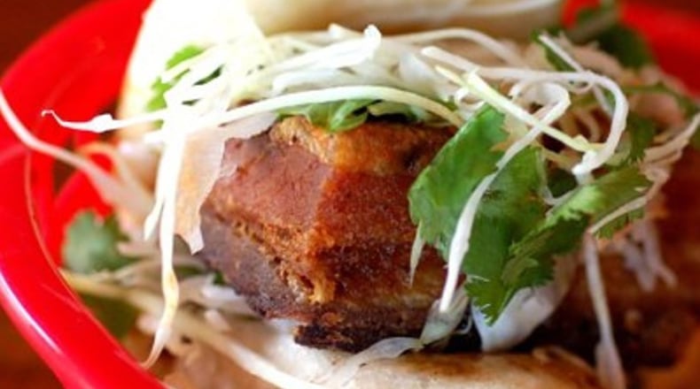 Latin-meets-Asian in the steamed pork belly bun with crispy smoked piloncillo pork belly, sambal, spicy tamarind sauce and cilantro slaw. (El Super Pan)