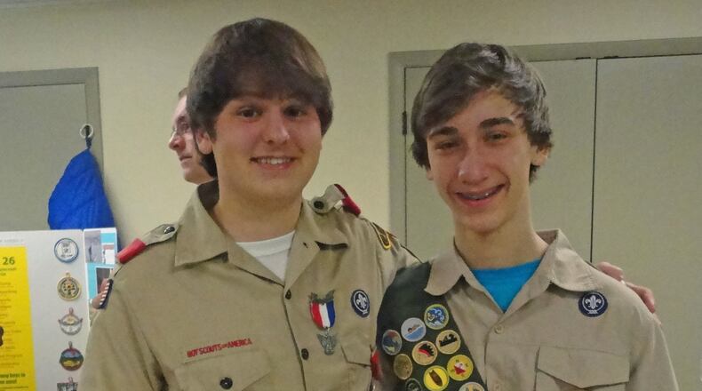 Nathan Henneberg-Verity (left) saved the life of John Allen, scouts in Norcross, during a recent trip and was awarded one of scouting s highest honors.