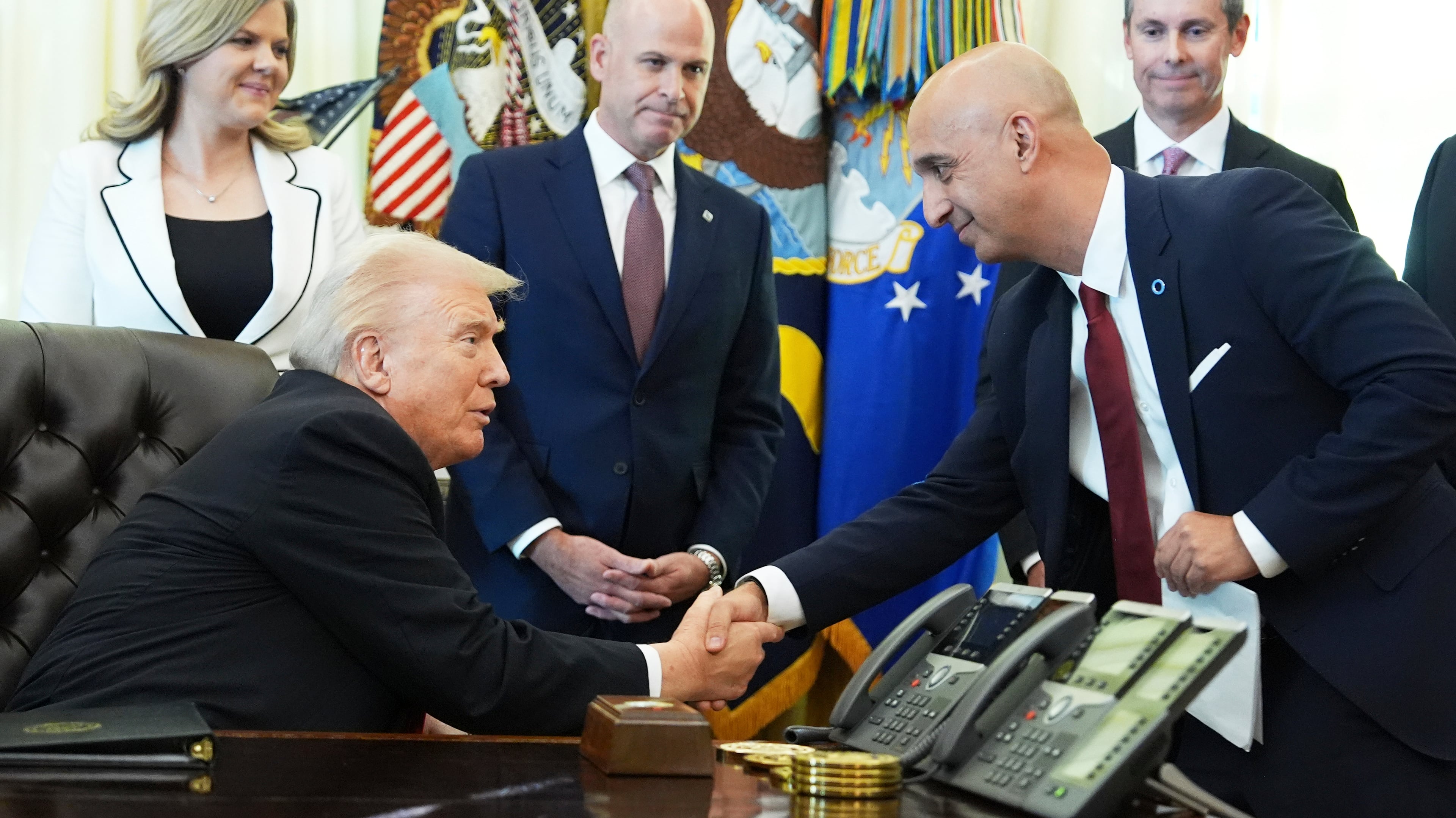 President Donald Trump, left, shakes the hand of Novo Nordisk President and CEO Mike Doustdar during an event about drug prices, Thursday, Nov. 6, 2025, in the Oval Office of the White House in Washington. (AP Photo/Evan Vucci)