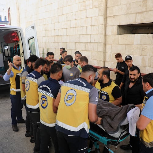 Members of the White Helmets carry the body of Mohammad Ghamira, a former White Helmets volunteer who died shortly after his release from jail, before his burial in the village of al-Haffa, Latakia province, Syria, Monday, Aug. 17, 2026. (AP Photo)
