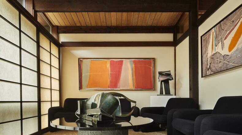 Shoji-style screens delineate the den; they originally served as the sole separation between the living room, bedrooms and kitchen, Anne Fleming says. The paintings are from the ’70s and the ’90s, says Carol Schulte; “They could have been done at the same time, or they could have been yesterday.” “Cut Bank” by Larry Zox (1996) hangs on the far wall, with an untitled acrylic on canvas by Kikuo Saito to the right. “The colors of the art are phenomenal in this room,” Anne says. (Benjamin Benschneider/The Seattle Times/TNS)