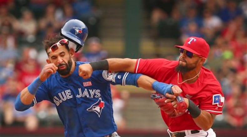 Toronto Blue Jays Jose Bautista (19) gets hit by Texas Rangers second baseman Rougned Odor (12) after Bautista slid into second in the eighth inning of a baseball game at Globe Life Park in Arlington, Texas, Sunday May 15, 2016. (Richard W. Rodriguez/Star-Telegram via AP)