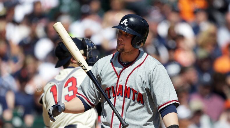 Braves' Chris Johnson flips his bat after striking out during the sixth inning of an interleague baseball game against the Detroit Tigers in Detroit, Saturday, April 27, 2013. (AP Photo/Carlos Osorio)