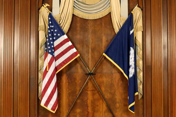 The U.S. and South Carolina flags as seen hanging in the South Carolina statehouse in 2021. (Jeffrey Collins/AP)