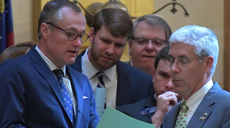 Lt. Gov. Casey Cagle (left) confers with state Sen. Bill Heath (right) and other senators during the winter session of the Legislature. HYOSUB SHIN / HSHIN@AJC.COM