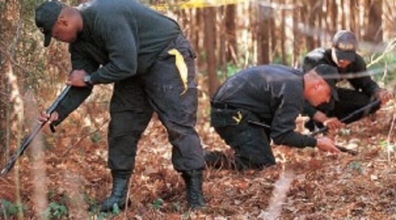 DeKalb police recruits were searching for clues to the identify of the the dead child found in DeKalb. This photograph was published in the March 2, 1999 Atlanta Constitution. The search for clues required 23 years. AJC PRINT ARCHIVES