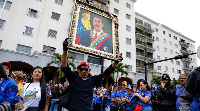Supporters of former Venezuelan President Nicolas Maduro rally calling for his release as he faces trial in the United States after being captured by U.S. forces, in Caracas, Venezuela, Friday, Jan. 14, 2026. (AP Photo/Cristian Hernandez)