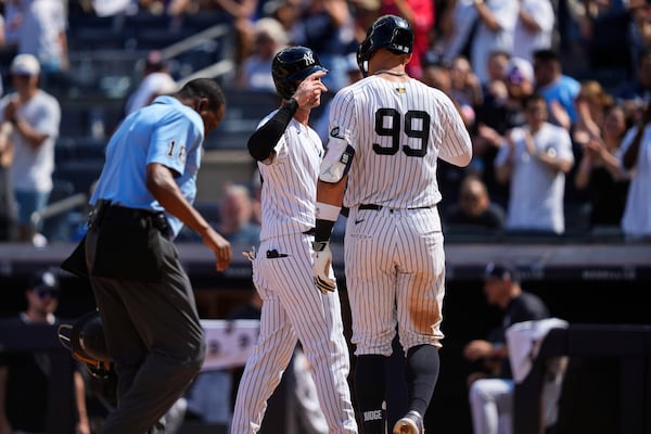 New York Yankees' Aaron Judge (99) celebrates with Cody Bellinger (35) after hitting a two run home run during the ninth inning of a baseball game against the Chicago Cubs, Saturday, July 12, 2025, in New York. (AP Photo/Yuki Iwamura)