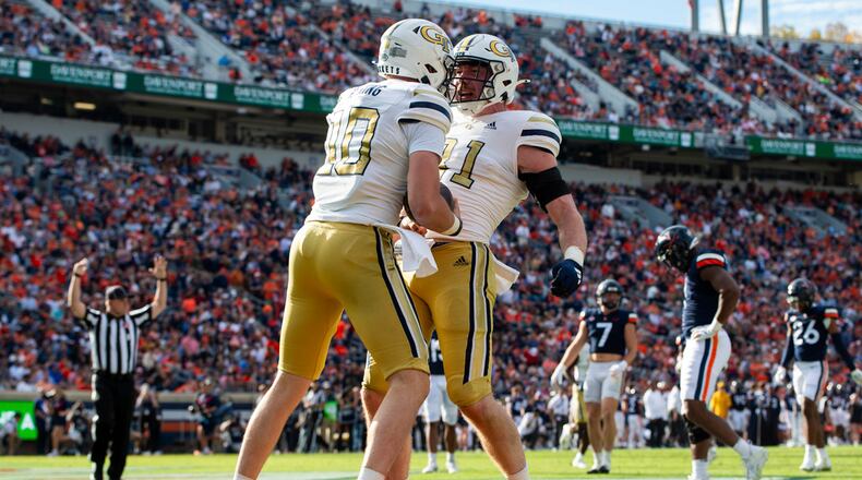 Georgia Tech quarterback Haynes King (10) celebrates with tight end Luke Benson (81) after scoring a touchdown during the first half of an NCAA college football game Saturday, Nov. 4, 2023, in Charlottesville, Va. (AP Photo/Mike Caudill)