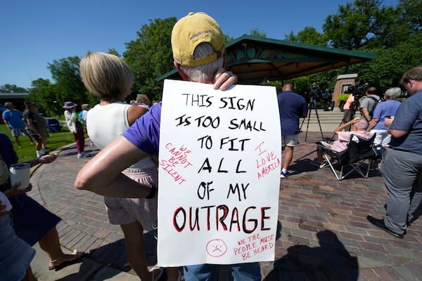 A local resident listen to a speech during an Iowa Democratic Party rally, Thursday, July 3, 2025, in Windsor Heights, Iowa. (AP Photo/Charlie Neibergall)