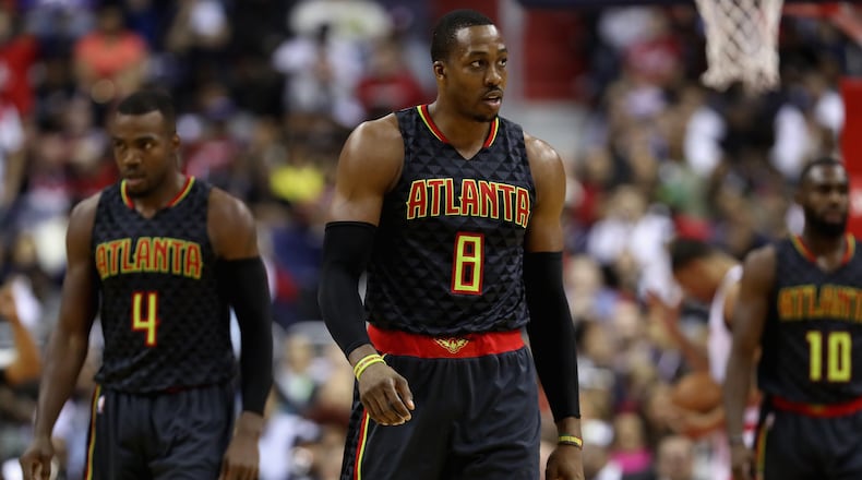 Dwight Howard (8) and Paul Millsap (4) of the Atlanta Hawks walk off the floor during the timeout in the first half against the Washington Wizards in Game 2 of the Eastern Conference Quarterfinals during the 2017 NBA Playoffs at Verizon Center on April 19, 2017 in Washington, DC. (Photo by Rob Carr/Getty Images)