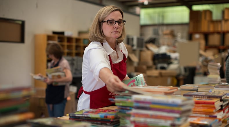 Melaney Smith sorts books in the Books for Keeps warehouse in Athens. Contributed by Books for Keeps.