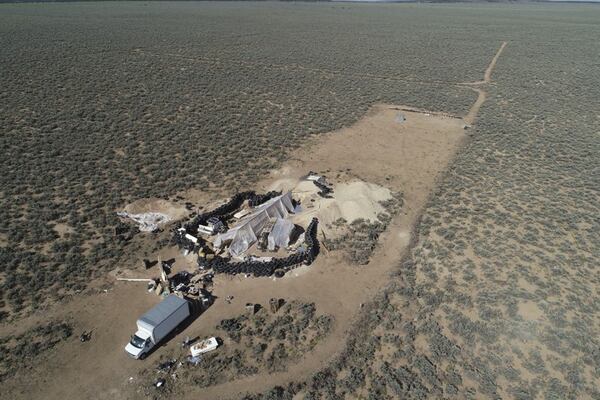 A makeshift compound in the desert area of Amalia, N.M., where 11 children were found living in filth and the body of a 3-year-old boy was discovered. (AP Photo/Brian Skoloff, File)