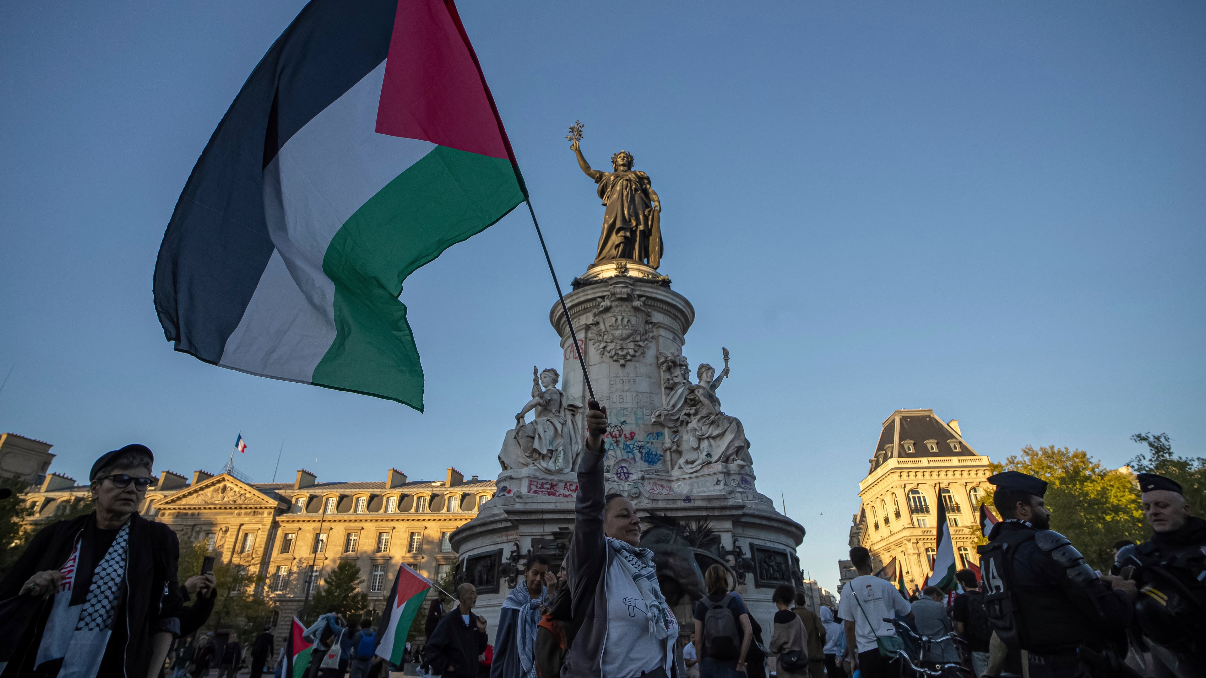 A woman holds a Palestinian flag during a pro-Palestinian gathering at Republic square in Paris, Wednesday, Sep. 17, 2025. (AP Photo/Aurelien Morissard)