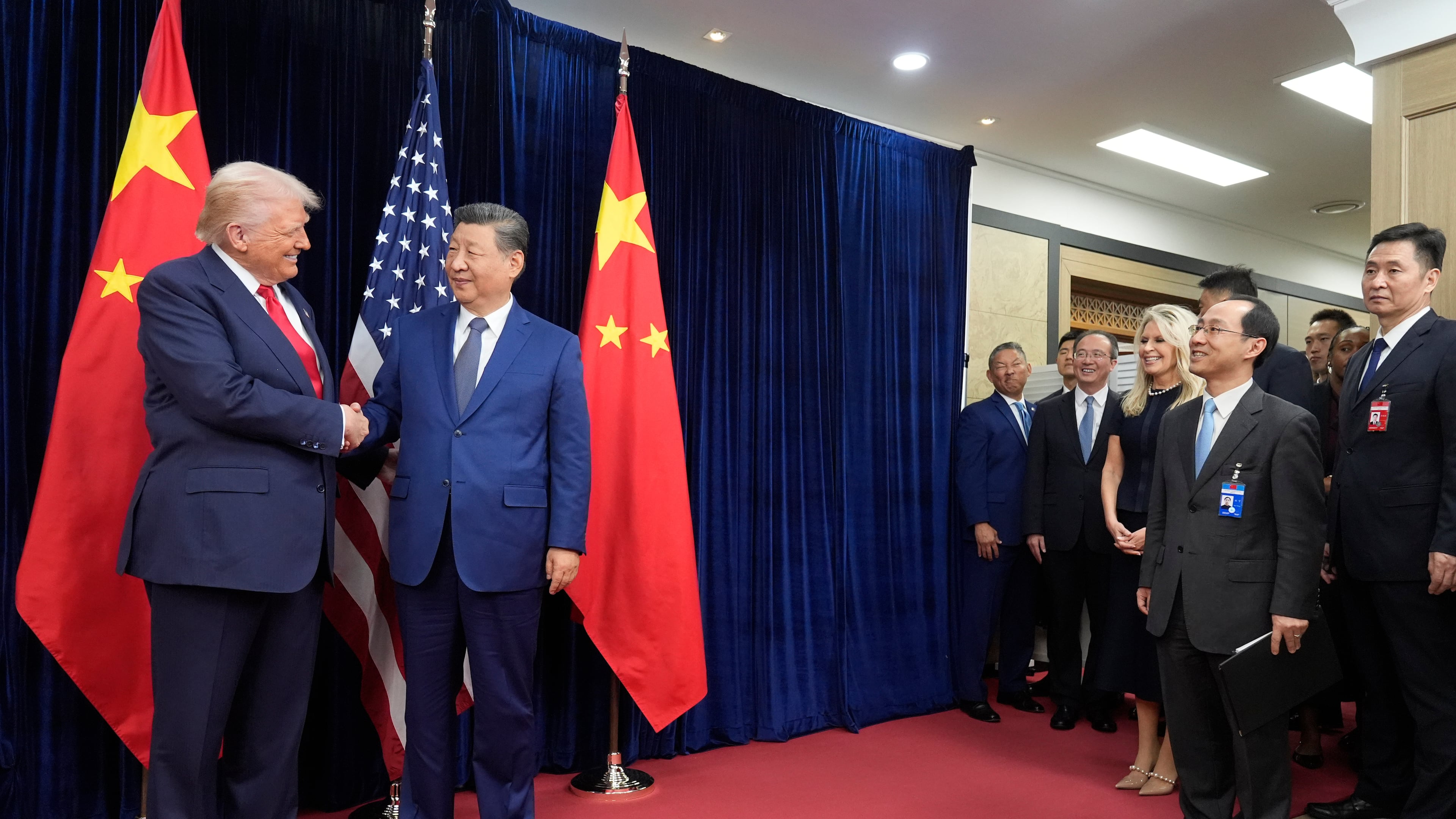 President Donald Trump, left, and Chinese President Xi Jinping shake hands before their meeting at Gimhae International Airport in Busan, South Korea, Thursday, Oct. 30, 2025. (AP Photo/Mark Schiefelbein)