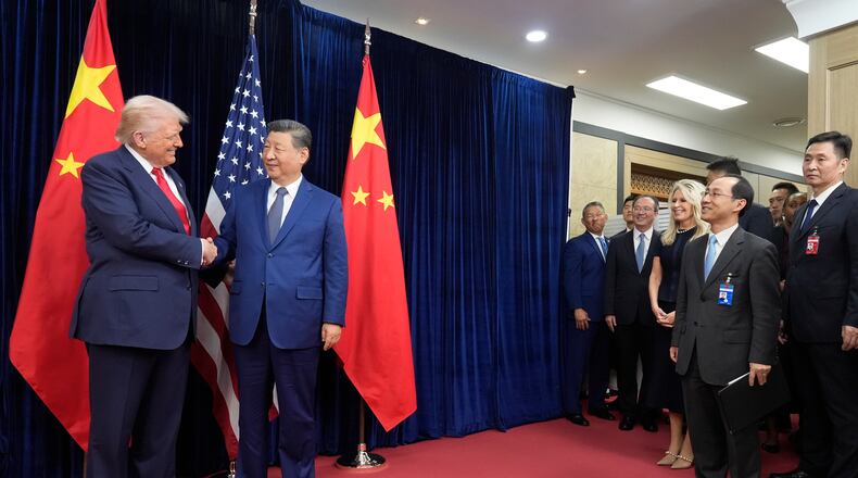 President Donald Trump, left, and Chinese President Xi Jinping shake hands before their meeting at Gimhae International Airport in Busan, South Korea, Thursday, Oct. 30, 2025. (AP Photo/Mark Schiefelbein)