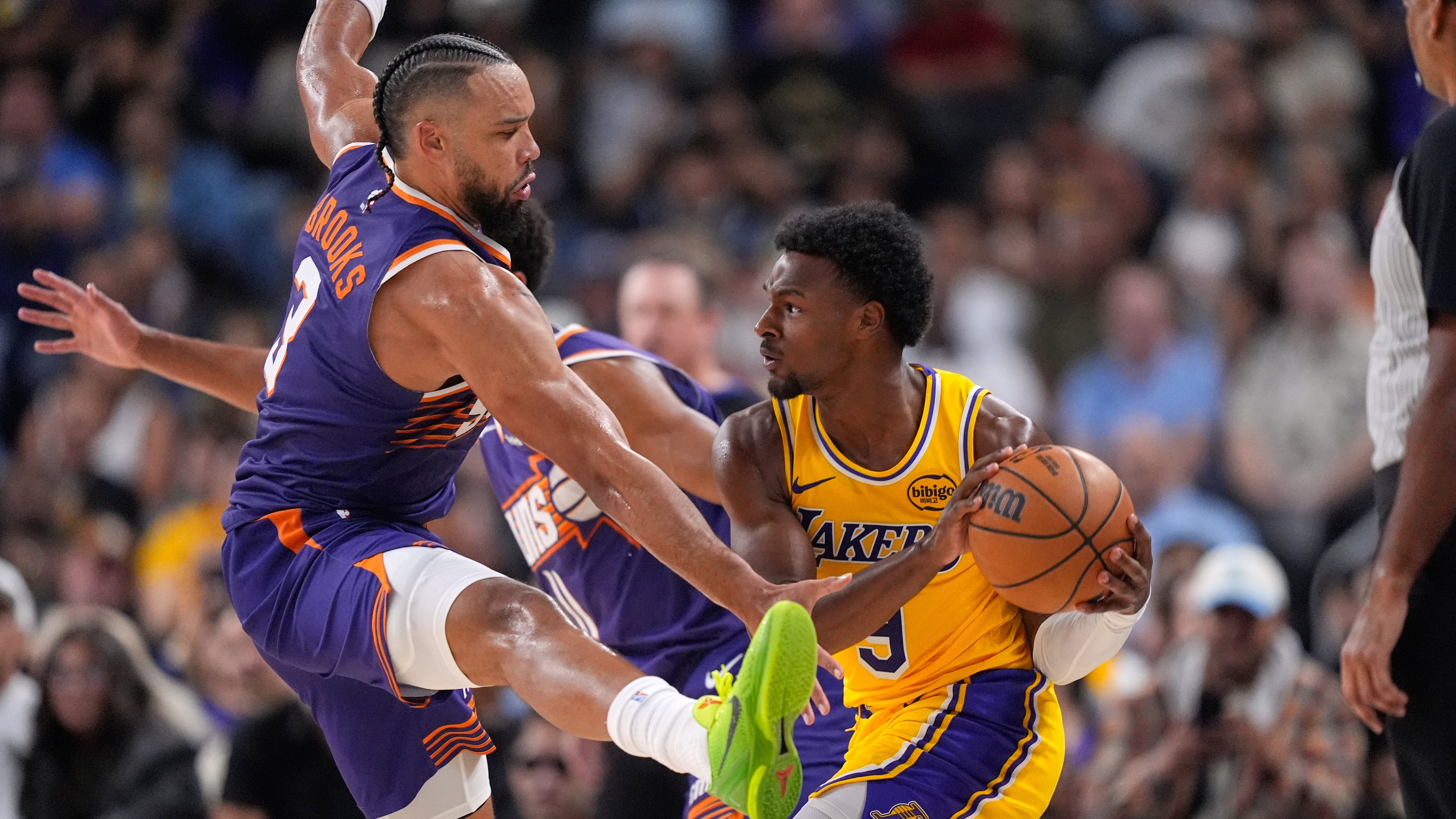 Los Angeles Lakers guard Bronny James, right, tries to pass while under pressure from Phoenix Suns forward Dillon Brooks during the second half of an NBA preseason basketball game Friday, Oct. 3, 2025, in Palm Desert, Calif. (AP Photo/Mark J. Terrill)