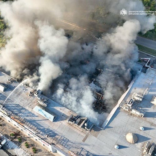 In this photo provided by the Ukrainian Military administration, firefighters work on a fire at a shopping mall following a Russian drone attack in Kryvyi Rih, Ukraine, Friday, Aug. 21, 2026. (Ukrainian Military administration via AP)