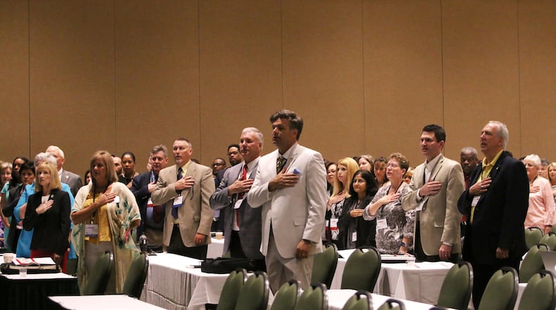 Georgia tax officials say the pledge of allegiance during the Georgia Association of Tax Officials Conference on May 6, 2019, at the Classic Center in Athens. A closely guarded provision of Georgia law allows county tax commissioners in Georgia to earn thousands of dollars in fees for collecting city taxes, on top of their county salaries. CHRISTINA R. MATACOTTA / CMATACOTTA@AJC.COM