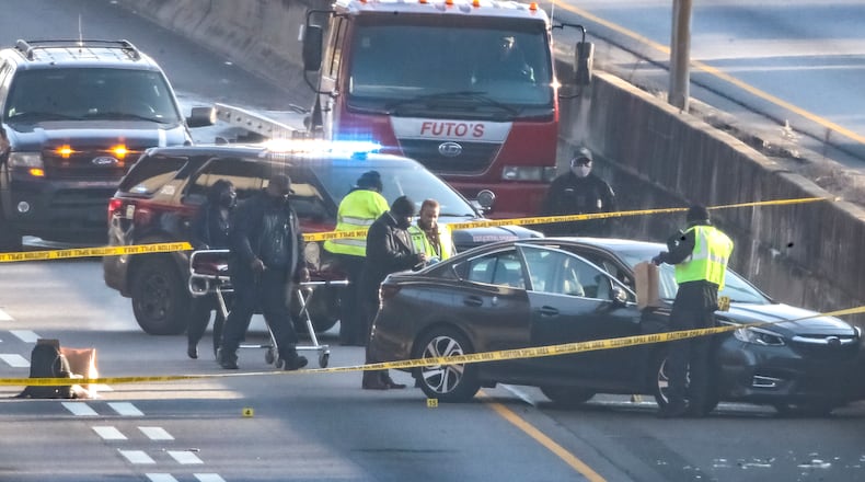 February 10, 2021 Atlanta: A double shooting in the southbound lanes of I-85 in Midtown left one man dead and wreaked havoc on Wednesday morning’s commute on Feb, 10, 2021. The fatal shooting brought traffic to a standstill about 5:15 a.m. just north of the Brookwood interchange. All lanes were shut down for about four hours as police investigated, leading to massive delays in Midtown, Buckhead and all through the northern suburbs, according to the WSB 24-hour Traffic Center. Drivers stuck behind the closure did not move for more than two hours before authorities began turning cars around. Backups stretched all the way to the Ga. 400 merge. An off-duty Jonesboro police officer discovered a dark-colored sedan near the entrance to I-75 North about 5:15 a.m. and found two men with gunshot wounds inside, Atlanta police Capt. Jason Smith said from the scene. One man was pronounced dead. The other was taken to Grady Memorial Hospital and survived his injuries. The officer initially thought he had come across a wreck, but quickly called for backup and tried to help the victims, Smith said. It wasn’t immediately clear Wednesday morning where the shots were fired from. Detectives are still working to piece together what prompted the fatal shooting and identify a suspect. Smith said detectives are trying to interview the surviving victim to find out exactly what happened. “This does not appear to be a random act,” Smith said. “It appears to be a dispute that had escalated.” All lanes reopened about 9:15 a.m. when police finally cleared the crime scene. “We always hate when we have to do that,” Smith said when asked about shutting down the interstate. “Unfortunately, we have to make sure that we process the crime scene appropriately, and it does take time.” (John Spink / John.Spink@ajc.com)