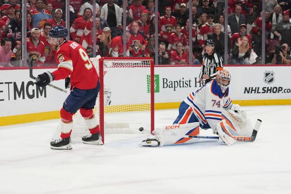 Florida Panthers center Sam Bennett (9) scores a goal against Edmonton Oilers goaltender Stuart Skinner (74) during the second period of Game 3 of the NHL Stanley Cup final Monday, June 9, 2025, in Sunrise, Fla. (AP Photo/Lynne Sladky)