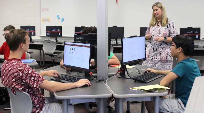 8/5/18 - Norcross - Beckie Mae, a teacher at Paul Duke STEM High School, helps her students login to their computers in an AP computer science class during their first day at school on Monday, August 6. Jenna Eason / Jenna.Eason@coxinc.com