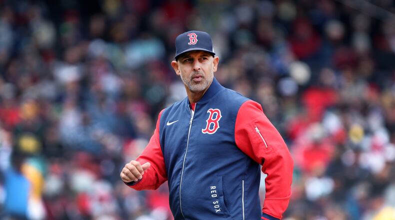 Boston Red Sox' manager Alex Cora walks back to the dugout after a mound visit during a baseball game against the Detroit Tigers, Monday, April 20, 2026, in Boston. (AP Photo/Jim Davis)