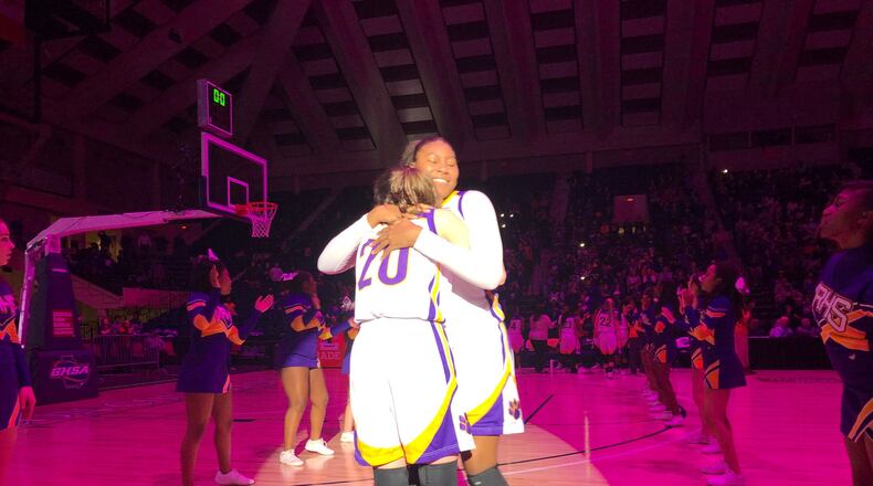 Deasia Merrill (right) is greeted by teammate Hannah Goen (No. 20) during introductions for the state championship game.