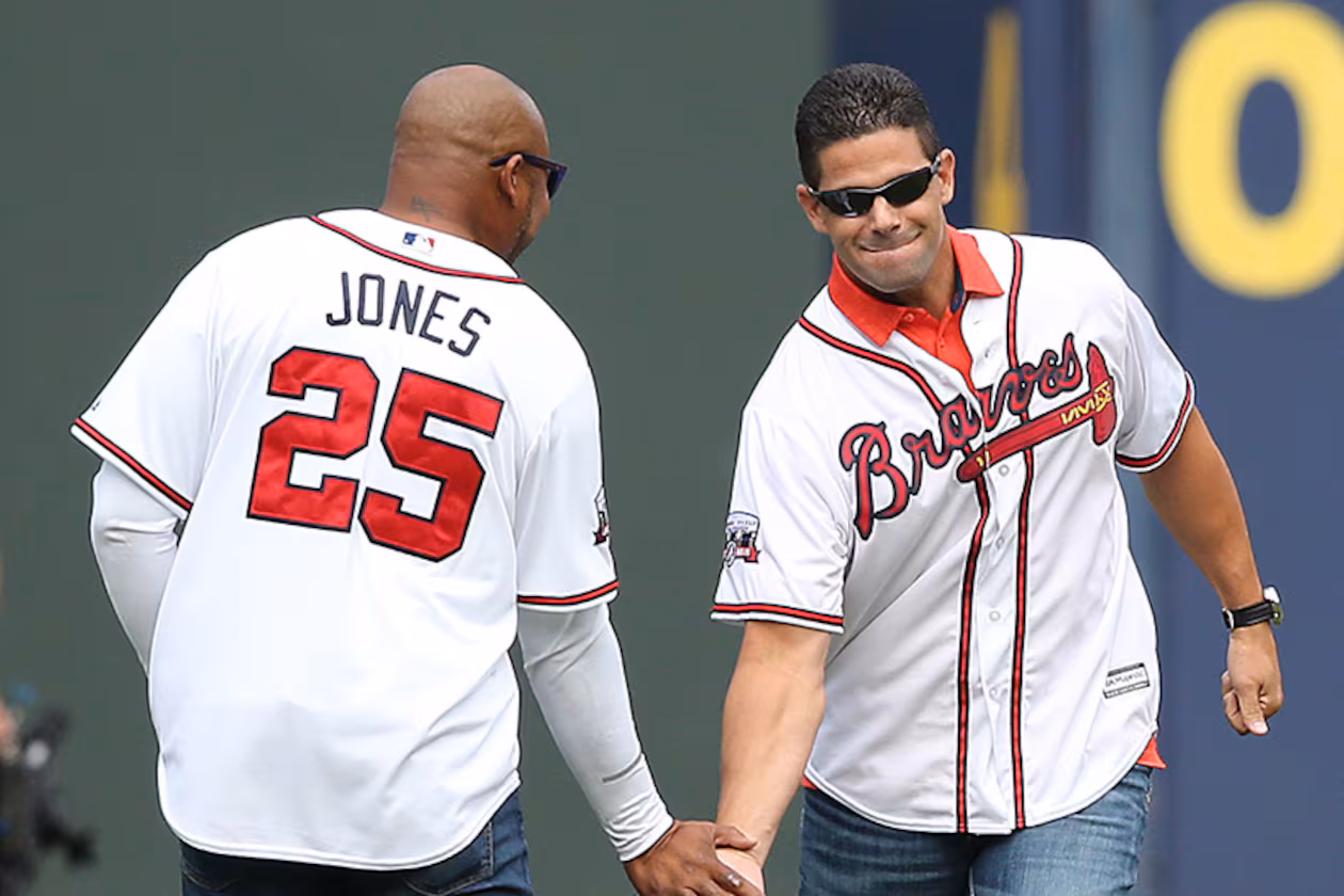 Braves greats Andruw Jones and Javy Lopez give each other five while taking the field for the team's final game at Turner Field on Sunday, Oct. 2, 2016, in Atlanta. (Curtis Compton/AJC)