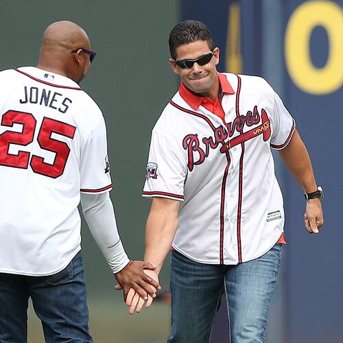 Braves greats Andruw Jones and Javy Lopez give each other five while taking the field for the team's final game at Turner Field on Sunday, Oct. 2, 2016, in Atlanta. (Curtis Compton/AJC)