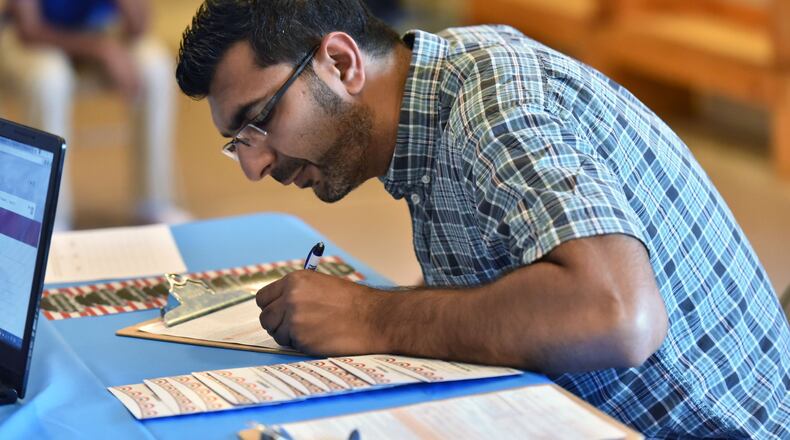 Mehbs Omar registers to vote during Friday Prayers at Madina institute, Islamic educational institution, in Duluth on Friday, September 9. HYOSUB SHIN / HSHIN@AJC.COM