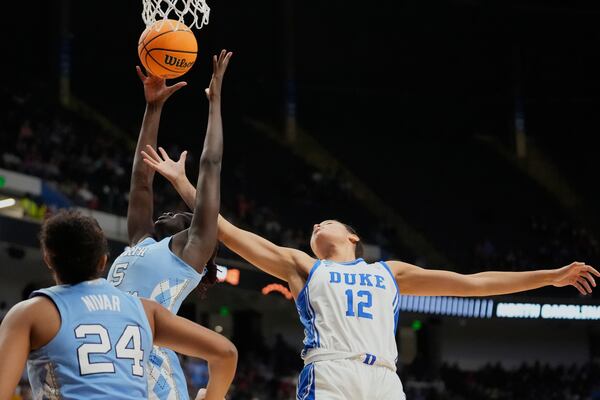 North Carolina forward Maria Gakdeng (5) and Duke forward Delaney Thomas (12) battle under the basket during the first half in the Sweet 16 of the NCAA college basketball tournament, Friday, March 28, 2025, in Birmingham, Ala. (AP Photo/Gerald Herbert)
