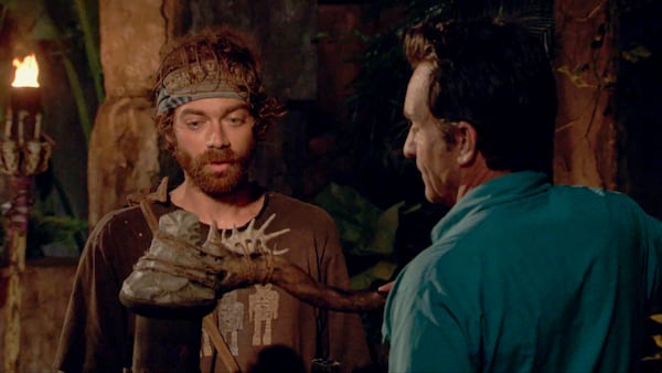 Christian Hubicki, a former post-doc student at Georgia Tech, watches his flame get snuffed out by Jeff Probst during the 13th episode of Season 37 of "Survivor." (CBS)