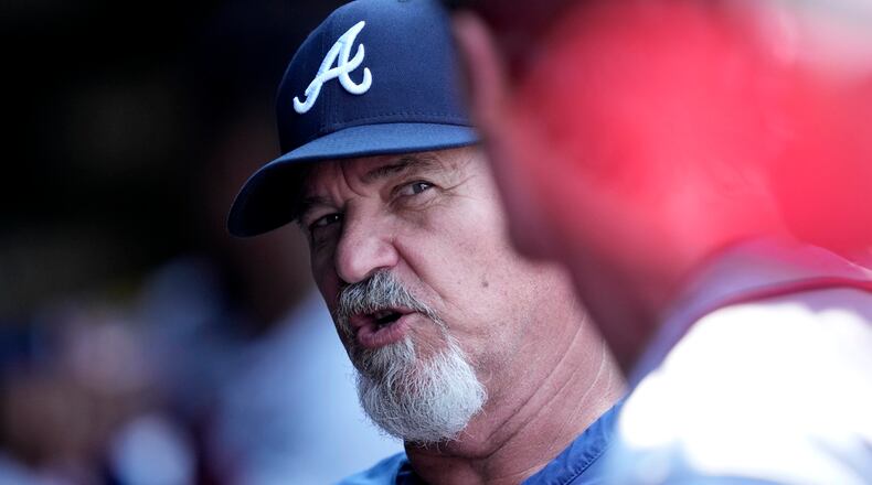 Atlanta Braves pitching coach Rick Kranitz talks with starter Max Fried in the dugout after the third inning of a baseball game against the Chicago Cubs Friday, Aug. 4, 2023, in Chicago. (AP Photo/Charles Rex Arbogast)
