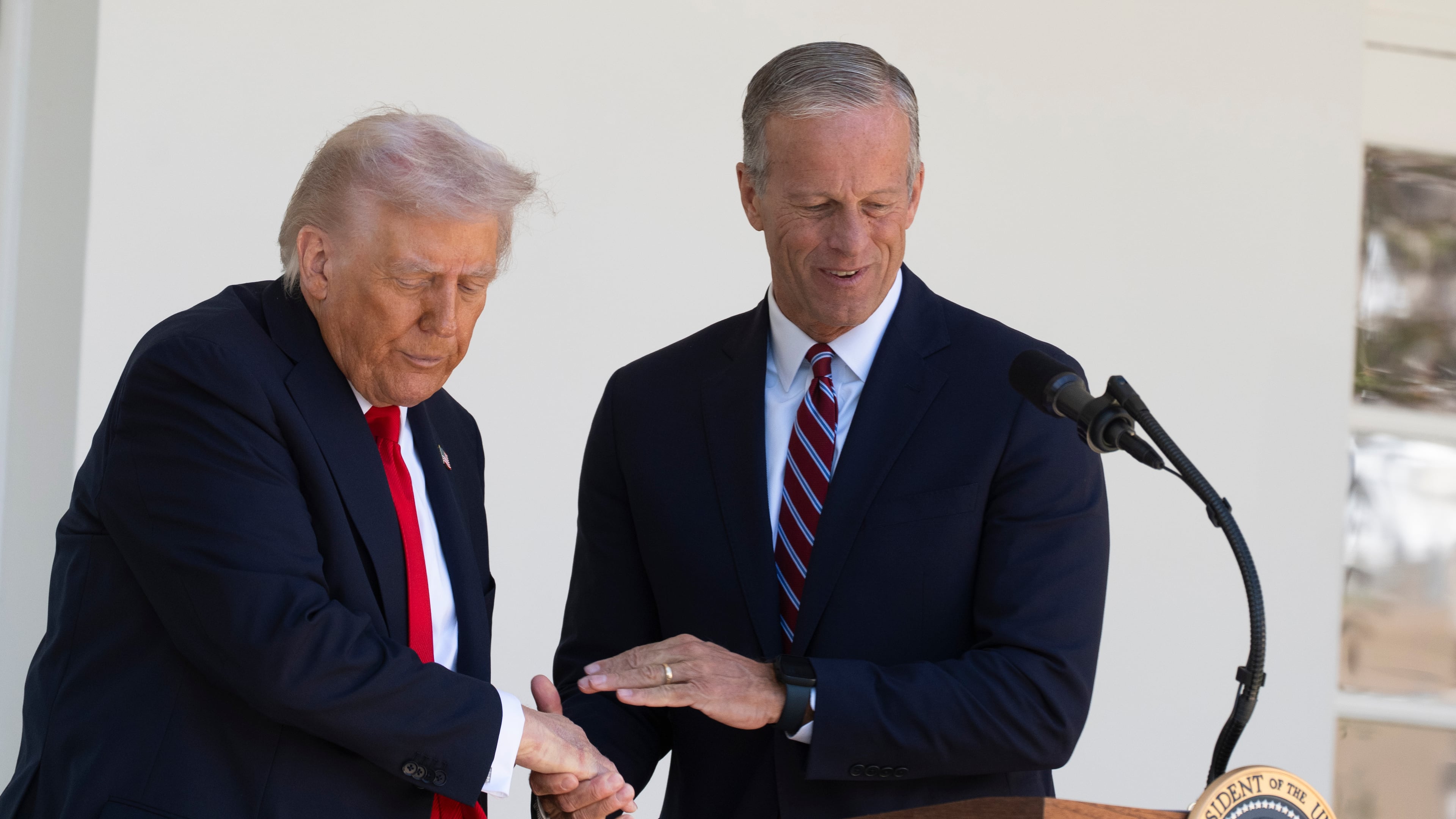 President Donald Trump shakes hands with Senate Majority Leader John Thune, R-S.D., right, during a lunch with Republican Senators on the Rose Garden patio at the White House, Tuesday, Oct. 21, 2025, in Washington. (AP Photo/Manuel Balce Ceneta)