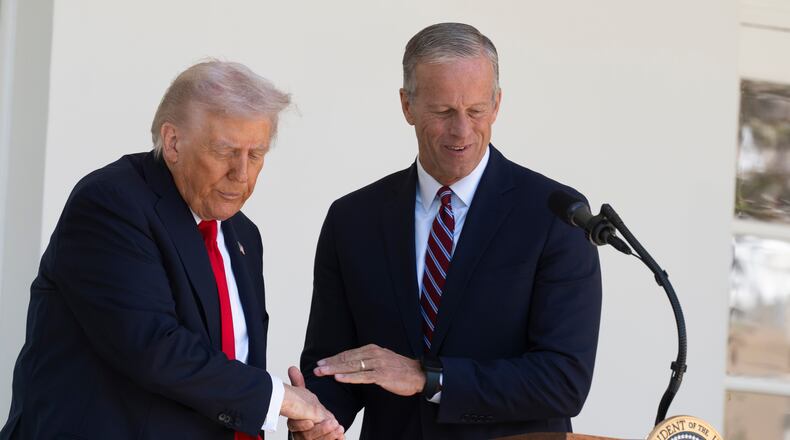 President Donald Trump shakes hands with Senate Majority Leader John Thune, R-S.D., right, during a lunch with Republican Senators on the Rose Garden patio at the White House, Tuesday, Oct. 21, 2025, in Washington. (AP Photo/Manuel Balce Ceneta)
