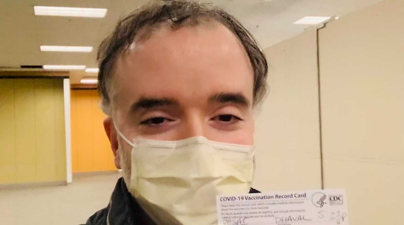 Dr. Dhaval Desai, who is Emory Saint Joseph’s director of hospital medicine, holds up his COVID-19 vaccination card  after getting the vaccine Thursday.
PROVIDED.