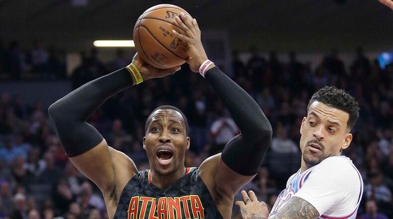 Atlanta Hawks center Dwight Howard, left, reacts after being called for a foul during the first half of the team’s NBA basketball game against the Sacramento Kings on Friday, Feb. 10, 2017, in Sacramento, Calif. At right is Kings forward Matt Barnes. (AP Photo/Rich Pedroncelli)