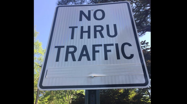 Tape covers the "During the I-85 Closure" part of a sign at the corner of Lindrige Drive NE and Lindbergh Drive NE in Buckhead.